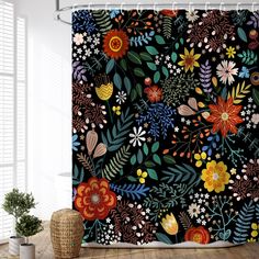 the shower curtain is decorated with colorful flowers and leaves on a black background, along with a potted plant