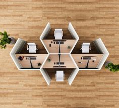 overhead view of an office cubicle with desks, chairs and plants on the floor