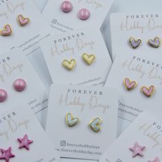 six pairs of pink and gold heart shaped studs on white cards with words forever baby day