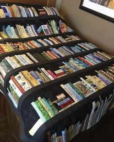 a bed covered in lots of books on top of it