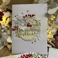 a close up of a greeting card on a table with flowers and other decorations around it