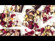 several pieces of chocolate with nuts and cranberry toppings