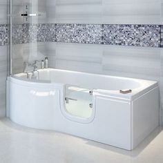 a white bath tub sitting inside of a bathroom next to a walk - in shower