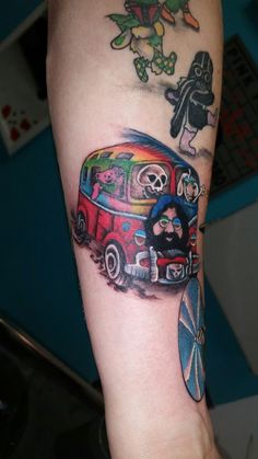 a person with a tattoo on their arm holding a skateboard and an old school vw bus