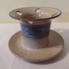 a white and blue cup sitting on top of a saucer