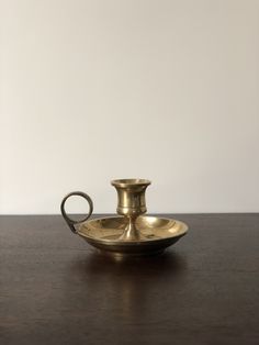 an antique brass oil lamp on a wooden table