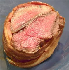 a piece of meat sitting on top of a blue plate