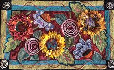 a close up of a rug with sunflowers and flowers on it's border