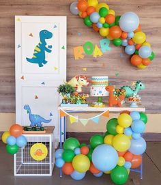 a dinosaur birthday party with balloons and decorations