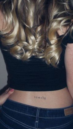 the back of a woman's stomach with her name written on it