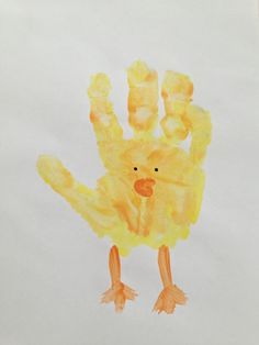 a child's handprint with a yellow bird on it