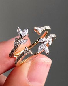 a person is holding two rings with diamonds on them in their hand and the other one has