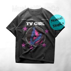 a black t - shirt with pink stars on it and the words tv girl written in purple