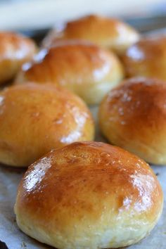 freshly baked rolls sitting on top of a baking sheet