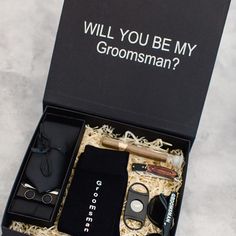 an open box containing grooms items and the words will you be my groomsman?