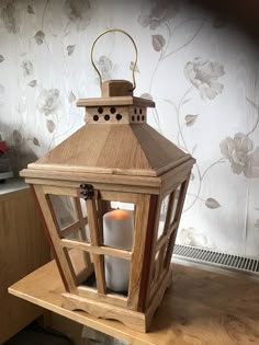 a wooden lantern sitting on top of a table