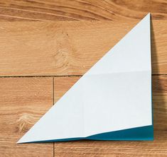 an origami piece sitting on top of a wooden floor