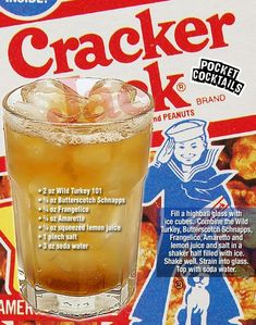 a close up of a drink in a glass near a package of cracker cookies