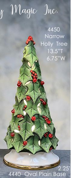 a ceramic christmas tree with red berries on it