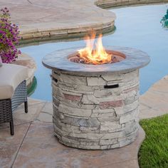 a fire pit sitting next to a swimming pool