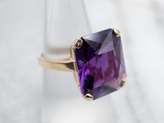 This exquisite yellow gold ring is set with a stunningly faceted Amethyst in a classic solitaire style. Expertly crafted, this cocktail ring is an eye-catching statement piece for any occasion.Metal: 14K Yellow GoldGem: Amethyst 16.00 CaratsGem Measurements: 14.7 x 18.0 mm, Emerald CutRing Size: 7Marks: "14K" Stamped on the inside band Luxury Faceted Amethyst Ring For Formal Occasions, Luxury Faceted Amethyst Ring For Formal Events, Formal Faceted Amethyst Ring Fine Jewelry, Formal Amethyst Ring With Diamond Cut, Purple Faceted Ring For Formal Occasions, Formal Faceted Purple Ring, Formal Purple Faceted Ring, Formal Faceted Amethyst Ring, Formal Solitaire Amethyst Ring With Emerald Cut