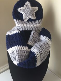 a crocheted hat and scarf on a mannequin