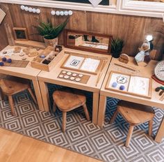 a wooden table topped with lots of different types of items on top of a rug