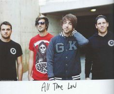 three men standing next to each other in front of a building with the caption all time low