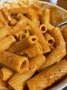 a white bowl filled with pasta and sauce