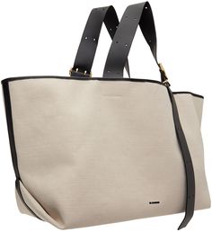 Canvas tote in beige. · Grained leather trim throughout · Adjustable pin-buckle shoulder straps · Logo bonded at face · Magnetic closure · Patch pocket at interior · Grained leather lining · H13 x W26 x D9 Supplier color: Natural Office Canvas Shoulder Bag With Gold-tone Hardware, Cream Bags With Leather Trim For Work, Cream Leather Trim Bag For Work, Beige Leather Trim Shoulder Bag For Office, Office Beige Shoulder Bag With Leather Trim, Beige Shoulder Bag With Leather Trim For Office, Cream Workwear Bags With Leather Trim, Beige Shoulder Bag With Handle Drop In Coated Canvas, Luxury Textured Leather Bags With Canvas Material