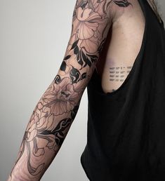 a man with a flower tattoo on his arm