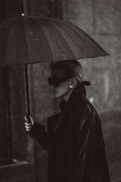 a woman holding an umbrella in the rain