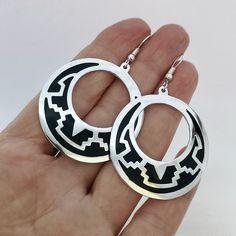 "These stunning Aztec hoops are handcrafted in Mexico. This is a traditional Aztec design that was widely used in prehispanic artwork and architecture. Jet black enamel was set into the intricate Grecas design setting off the silver background. The earrings and ear wires are silver plated. The dimensions of the earrings are 2.5\" inches Long x 1.5\" inches Wide. If you've got any questions don't hesitate to ask me. This item comes gift wrapped in an organza pouch. This is part of a collection of Southwestern Silver Round Hoop Earrings, Ornate Silver Hoop Earrings With Oxidized Finish, Aztec Jewelry Silver, Aztec Jewelry Ancient, Aztec Earrings, Hummingbird Earrings, Abalone Earrings, Boho Chic Earrings, Silver Background