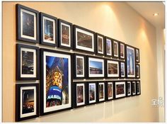 a group of framed pictures hanging on the side of a wall next to an ebay sign