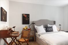 a bed sitting in a bedroom next to a wooden desk