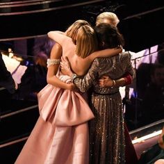 two women hug each other as they stand in front of an audience at the oscars