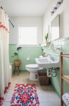 before and after photos of a bathroom remodel in mint green with white fixtures