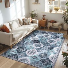 a living room filled with furniture and a blue rug