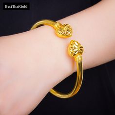 Item:  1 x Bangle Bracelet For:  Women, Girl Type:  GOLD PLATED over Brass, Nickel free  Purity:  96.5% Surface:  Carved & Shiny -------------------------- Diameter:  ~6 cm Circumference:  ~19 cm Weight:~ 14.5 grams -------------------------- * 24K Gold Plated Jewelry * Look like Real Gold * The weight is the same as Real Gold * Nickel free / No Allergic ** Please read the item details completely and measure your wrist size , necklace length before ordering. The shop does not accept cancellation Gold Plated Heart Bangle Bracelet, Gold-plated Heart Bangle Bracelet, Festival Gold Bangle Bracelet, Festivals Gold Bangle Bracelet, Festival Gift Gold Bracelet, Gold Bracelet For Festivals, 22k Gold Bracelet Gift, Asian Vintage, Heart Bangle Bracelet