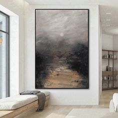 a painting hanging on the wall above a bed in a room with white walls and wooden floors