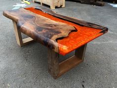 a table made out of wood and orange paint