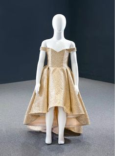 Gold is always celebrated as the royal colour and this hi-lo dress is made to give a royal look to your little fashionista. Designed with an off the shoulder corset bodice, the entire dress looks charming with the twinkling sequins. Visible boning enhances the fitted fitting of the bodice and gives a modern look to the little donner. Backless back is festooned with the lace up style to aid in getting the required fitting. The cut of this silhouette is perfect to be paired with some statement neck piece and some beautiful pair of shoes. Gold Ball Gown, Gold Prom Dress, High Low Prom Dress, Sweet 15 Dresses, Girls Ball Gown, Wedding Dresses For Kids, Gold Prom Dresses, High Low Prom Dresses, Dress Corset