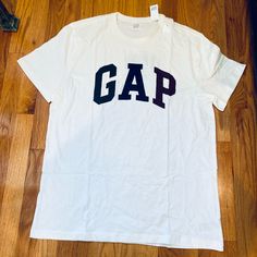 Gap Mens Large Cream Short Sleeve Tshirt New Never Used Tag Attached No Stains No Rips Color Is Cream Gap Logo “G” Dark Green “A” Dark Blue “P” Maroon Size Is Large Measurements 30” L 22” W Happy Poshing! Gap Short Sleeve Pre-shrunk T-shirt, Gap Relaxed Fit T-shirt With Letter Print, Gap Cotton T-shirt With Letter Print, White Gap T-shirt With Graphic Print, Gap White Graphic Print T-shirt, Gap Short Sleeve Tops With Letter Print, Gap White Graphic Tee T-shirt, White Graphic Tee By Gap, Gap Cotton Tops With Logo Print