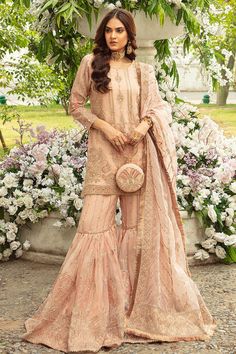 Beige Peach Heavily Embellished Kameez Sharara Pakistani Wedding Dress is a hand crafted and embroidered shirt with deep jeweled tones, machine embroidery. Designer Peach Dress With Intricate Embroidery, Peach Dress With Intricate Embroidery For High Fashion, Hand Embellished Semi-stitched Salwar Kameez For Eid, Designer Peach Dress With Resham Embroidery, Pink Hand Embellished Organza Anarkali Set, Peach Semi-stitched Dress For Designer Wear, Festive Peach Anarkali Set With Intricate Embroidery, Peach Resham Embroidery Dress For Reception, Peach Tailored Dress For Designer Wear