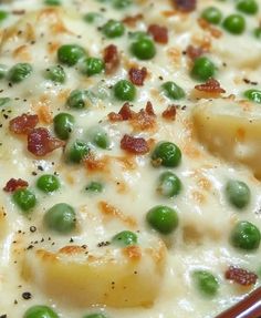 peas, potatoes and bacon are mixed together in a casserole with cream sauce