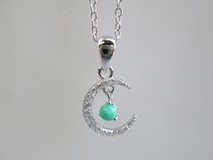 "Sterling silver necklace with a lovely simulated diamond CRESCENT MOON with a genuine turquoise ball. The moon over the earth. Minimalist look with just the right amount of sparkle. The pendant is 1/2\" tall with the sterling chain being 16\" long PLUS a 2\" extender. Stamped 925. You are going to LOVE this one!" Green Crescent Moon Charm Jewelry, Earth Minimalist, Necklace Turquoise, Crescent Moon Necklace, Palm Beach Fl, Genuine Turquoise, West Palm Beach, Moon Necklace, West Palm