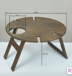 a wooden table with two legs and a hole in the middle that has been cut open