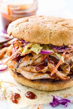 a pulled pork sandwich with coleslaw and ketchup