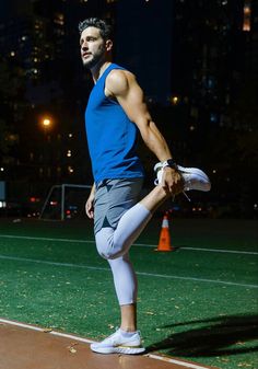 a man standing on top of a field holding a frisbee