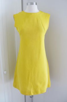 *vintage  60's bright yellow faille    sleeveless dress in about a size small/ medium  *high crew neck,    seamed bodice, slight a line skirt that falls past the knees.   back with  metal  zipper entry.  unlined. * excellent  vintage  condition tags/labels: leslie faye original measurements taken laying flat pit to pit: 16.5" waist: 14.5" hips: 18" overall length: 34" ( 2" hem) Fitted Vintage A-line Sleeveless Dress, Vintage Fitted A-line Sleeveless Dress, Chic Yellow Stretch Sleeveless Dress, Fitted Yellow Sleeveless Dress, Fitted Sleeveless Mod Dress, Fitted Vintage Sleeveless Dress For Spring, Mod Style Fitted Sleeveless Summer Dress, Fitted Mod Sleeveless Summer Dress, Mod Fitted Sleeveless Summer Dress